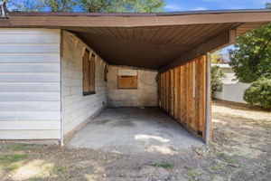 carport, boarded up windows