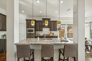 Updated kitchen with Dolomiti Alpine Granite and marble herringbone backsplash