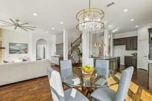 Custom lighting adorn the open concept kitchen/living