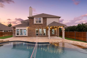 Backyard saltwater pool paradise with volleyball and beach entry