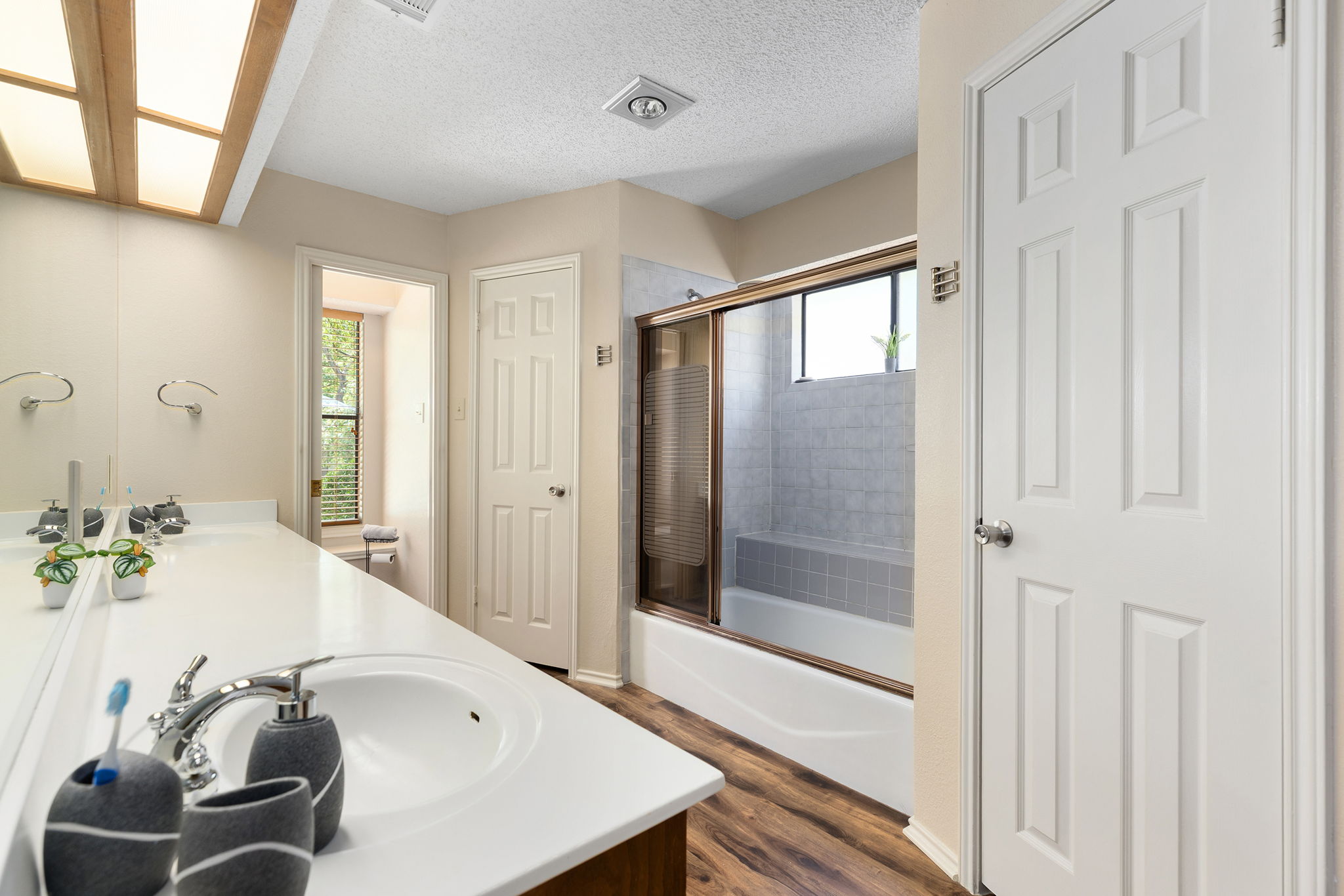 Downstairs primary bathroom with his 'n hers closets