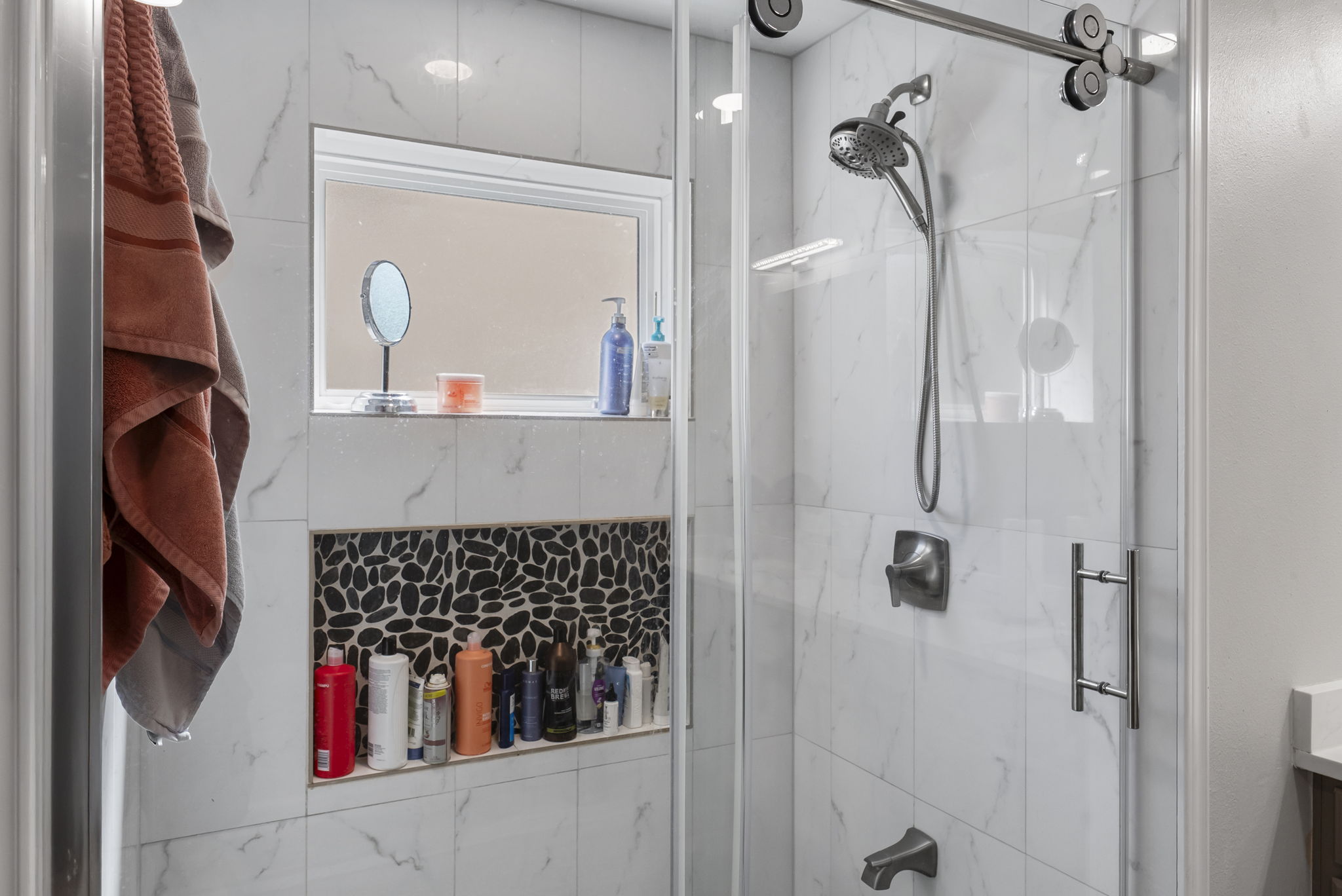 Lots of storage and light in this shower!