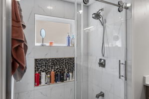 Lots of storage and light in this shower!
