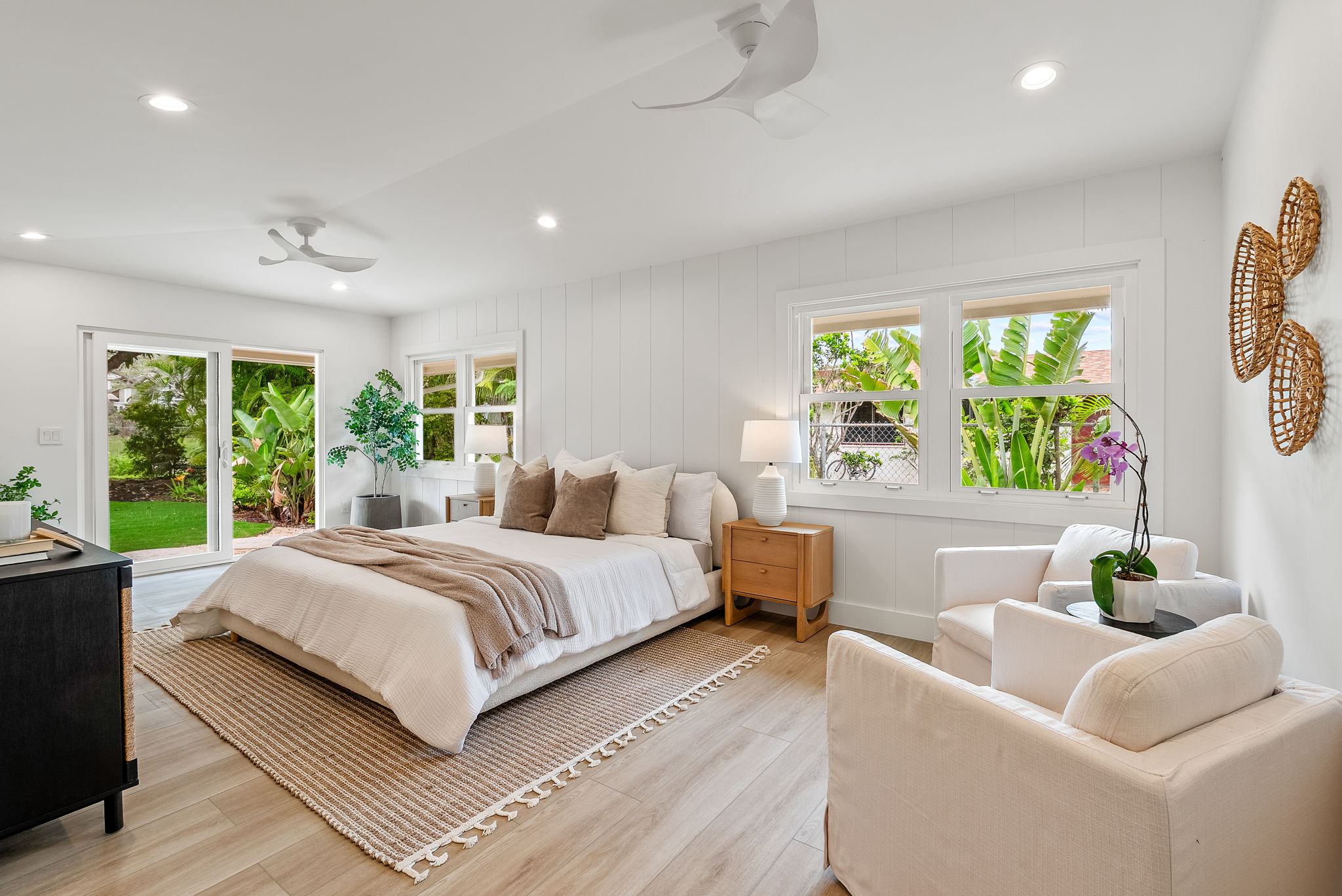 The primary bedroom retreat is a delight with vaulted ceilings, natural light throughout, lounge space, a large walk-in closet, sliders to the private landscaped backyard and outdoor shower.