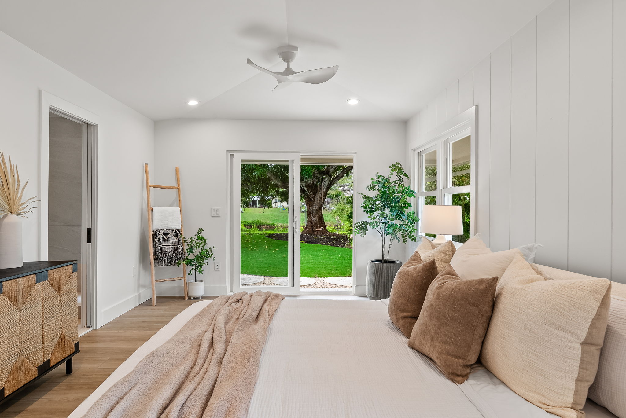 The primary bedroom retreat is a delight with vaulted ceilings, natural light throughout, lounge space, a large walk-in closet, sliders to the private landscaped backyard and outdoor shower.