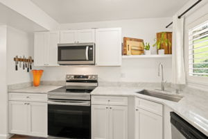 Marble Countertops and bright cheerful yet modern Kitchen with  Stainless Appliances and Nature Views