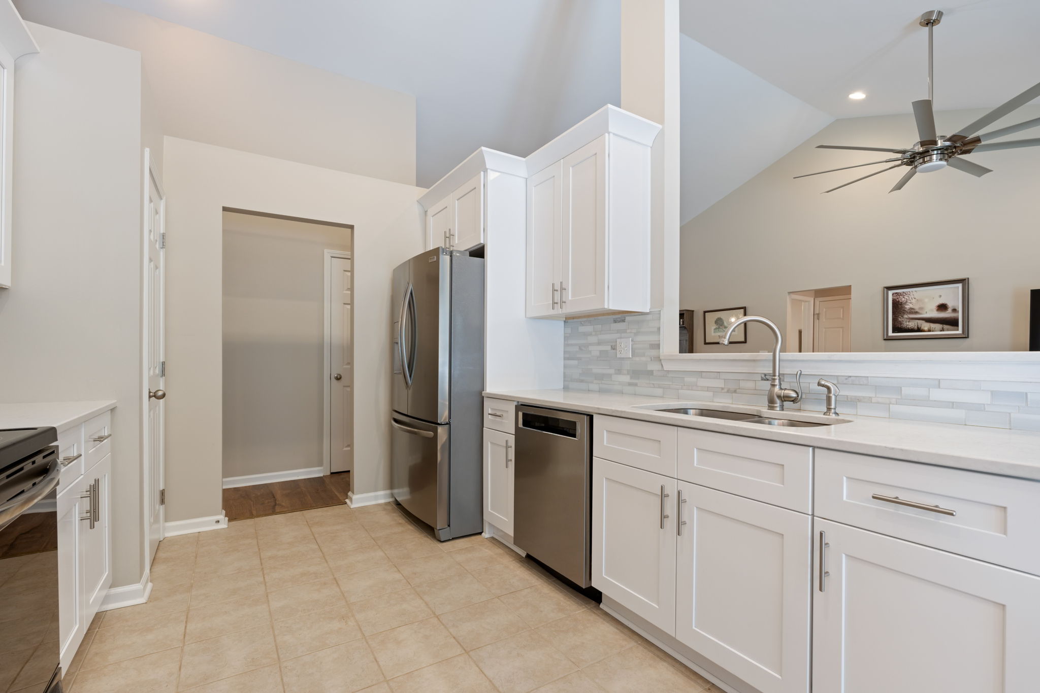 kitchen with upgraded backsplash, countertops & appliances