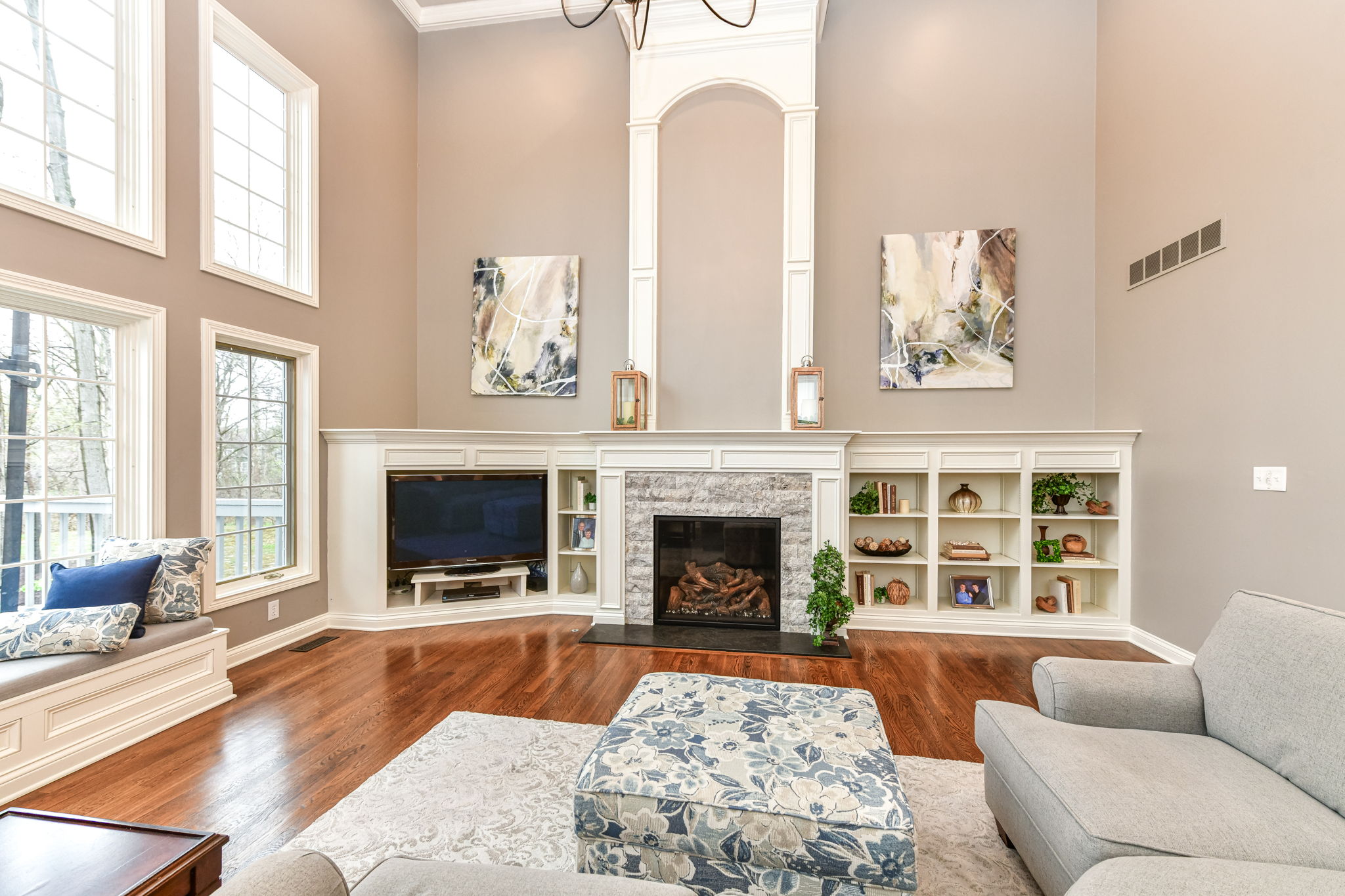 Great Room with Gorgeous Hardwood Flooring, Soaring 18' Ceiling, Fireplace and Tons of Natural Light