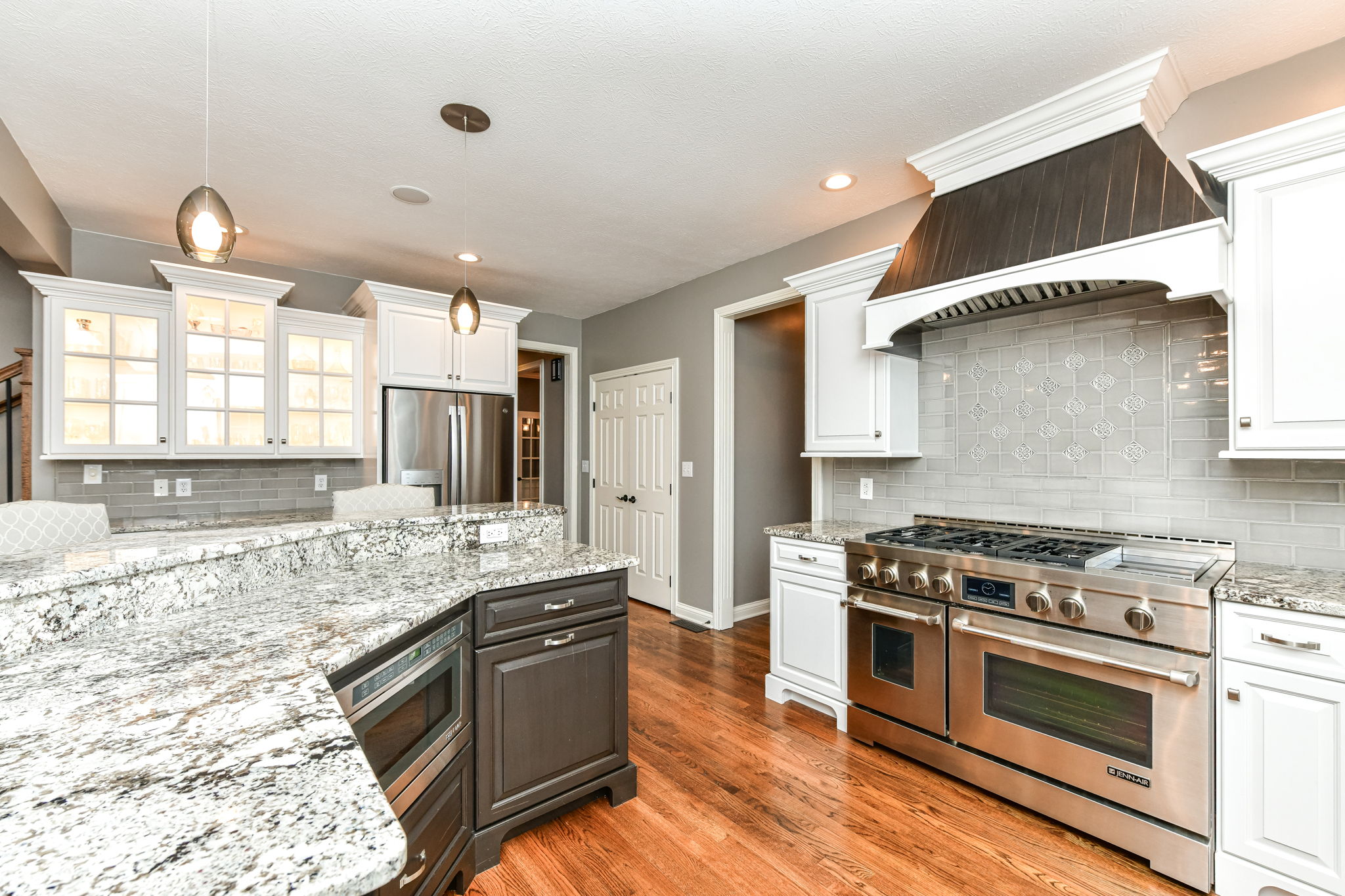 Upgraded Gourmet Kitchen with upgraded appliances and cabinets, center island and large walk-in pantry