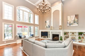 Great Room with Gorgeous Hardwood Flooring, Soaring 18' Ceiling, Fireplace and Tons of Natural Light