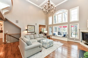 Great Room with Gorgeous Hardwood Flooring, Soaring 18' Ceiling, Fireplace and Tons of Natural Light
