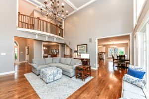 Great Room with Gorgeous Hardwood Flooring, Soaring 18' Ceiling, Fireplace and Tons of Natural Light