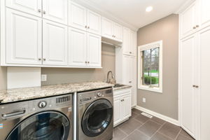Large Laundry Room with Custom Cabinets and Beautiful Tile Floors