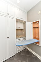 Large Laundry Room with Custom Cabinets and Beautiful Tile Floors