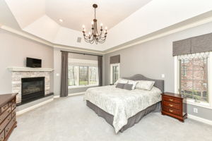 Spacious Main Level Primary Bedroom Ensuite with Cozy Fireplace