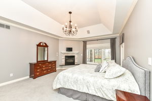 Spacious Main Level Primary Bedroom Ensuite with Cozy Fireplace