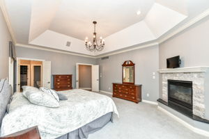 Spacious Main Level Primary Bedroom Ensuite with Cozy Fireplace