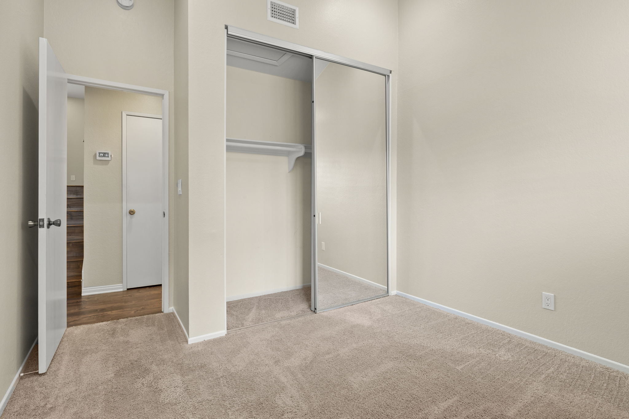 BR #3 on mid-level has mirrored closet doors, plantation shutters, vaulted ceiling & recessed lighting.