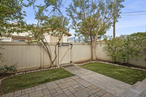Interior of fenced private front yard. Gated & somewhat secluded community pool (1 of multiple pools) located just outside front gate.