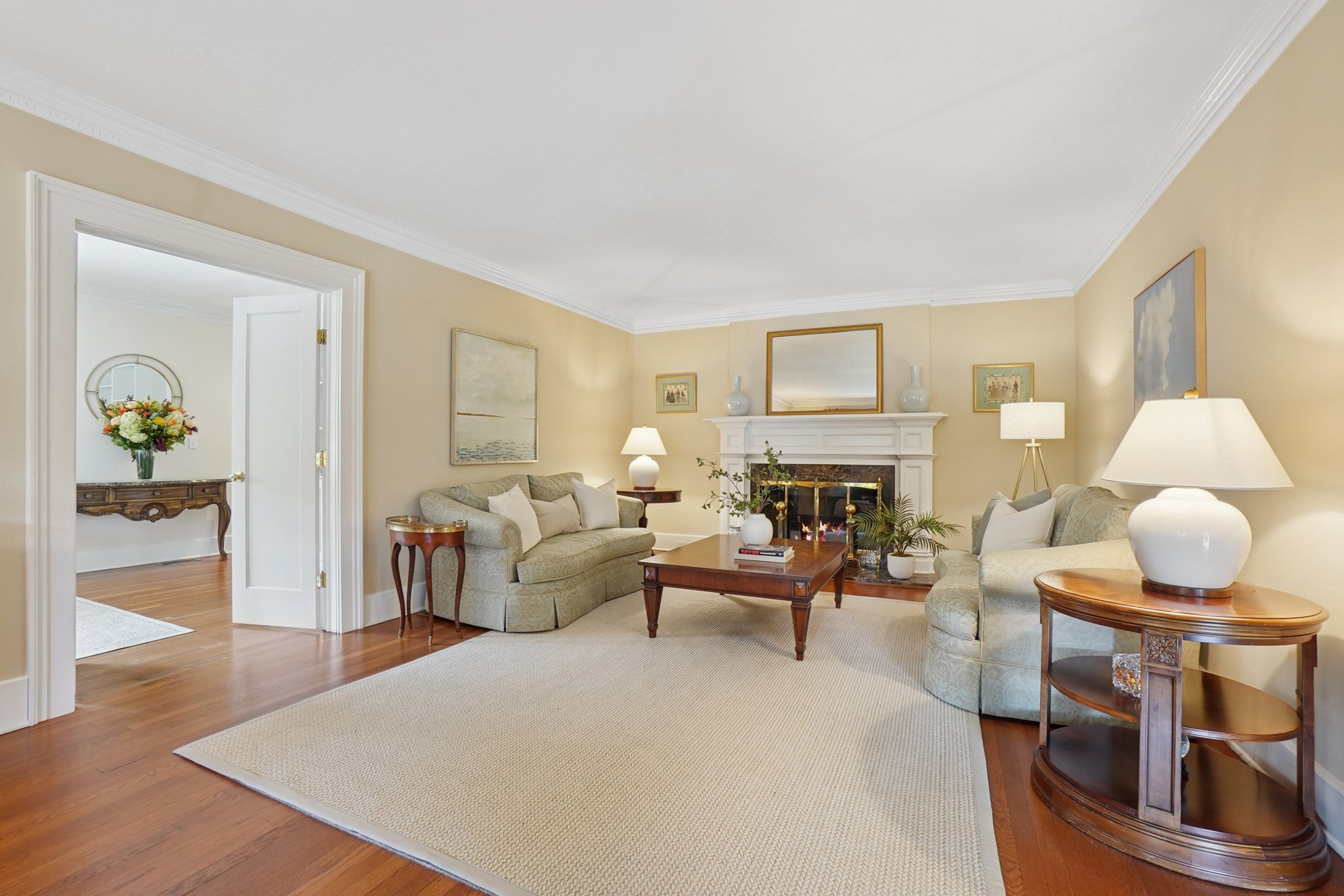 The living room's wood burning fireplace is perfect for lazy Sunday afternoons. (A glimpse in to in-law ensuite on first floor...)