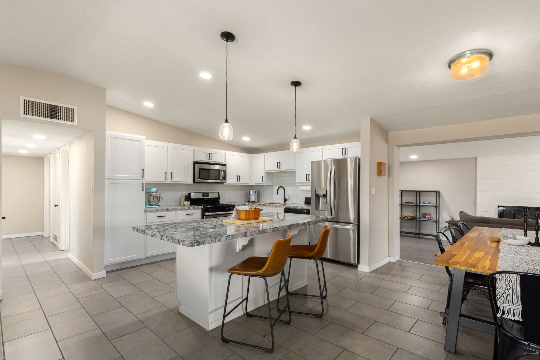 Updated kitchen with white cabinets, granite countertops and stainless steel appliances.