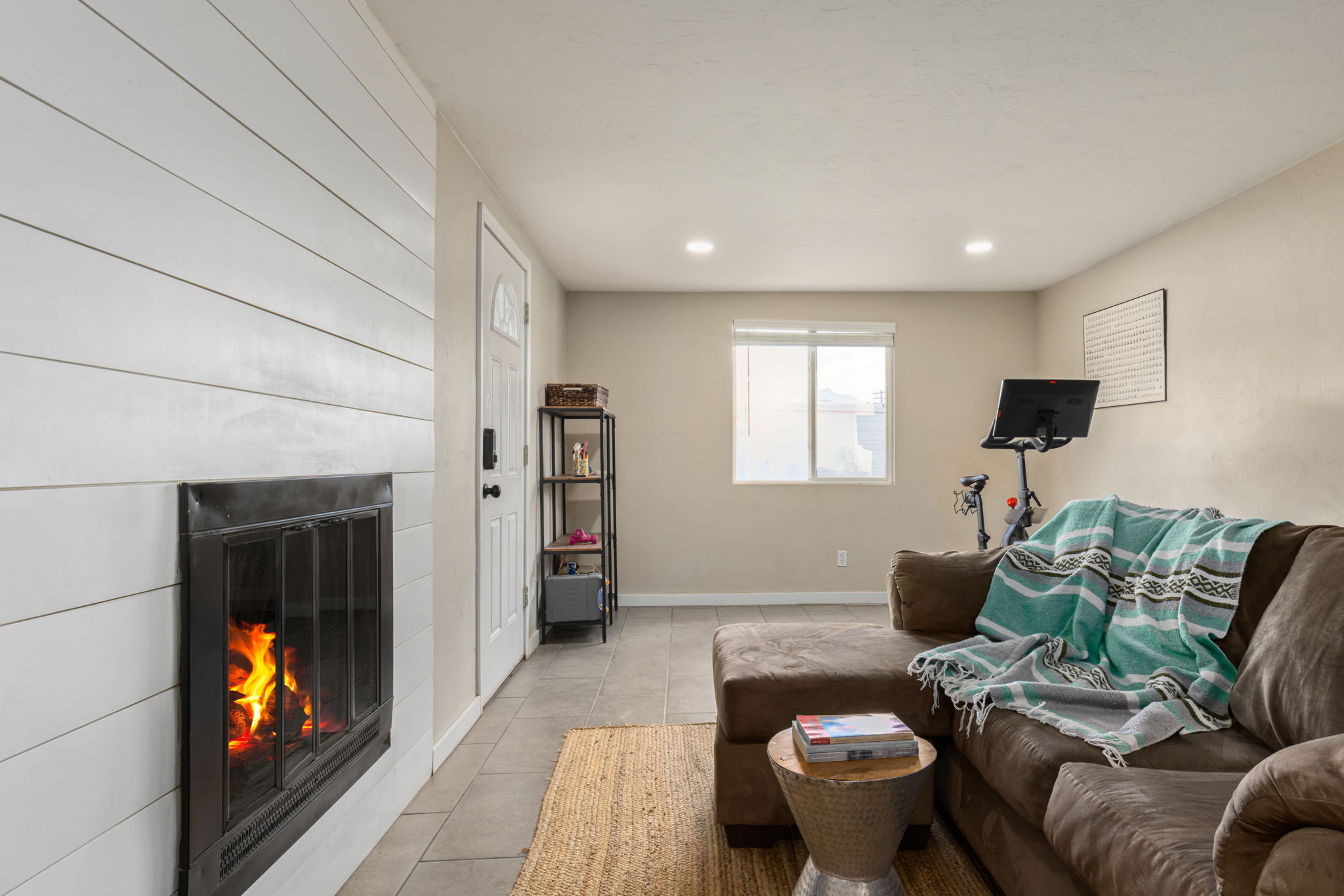 Family room off the dining area with wood burning fireplace and door to the backyard.
