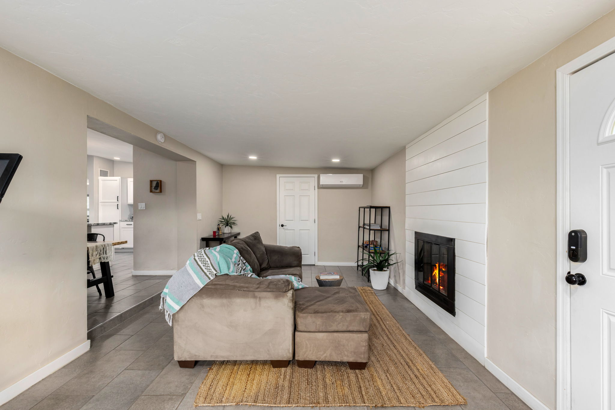 Landry room off the family room area with newer washer and dryer, plus water heater.