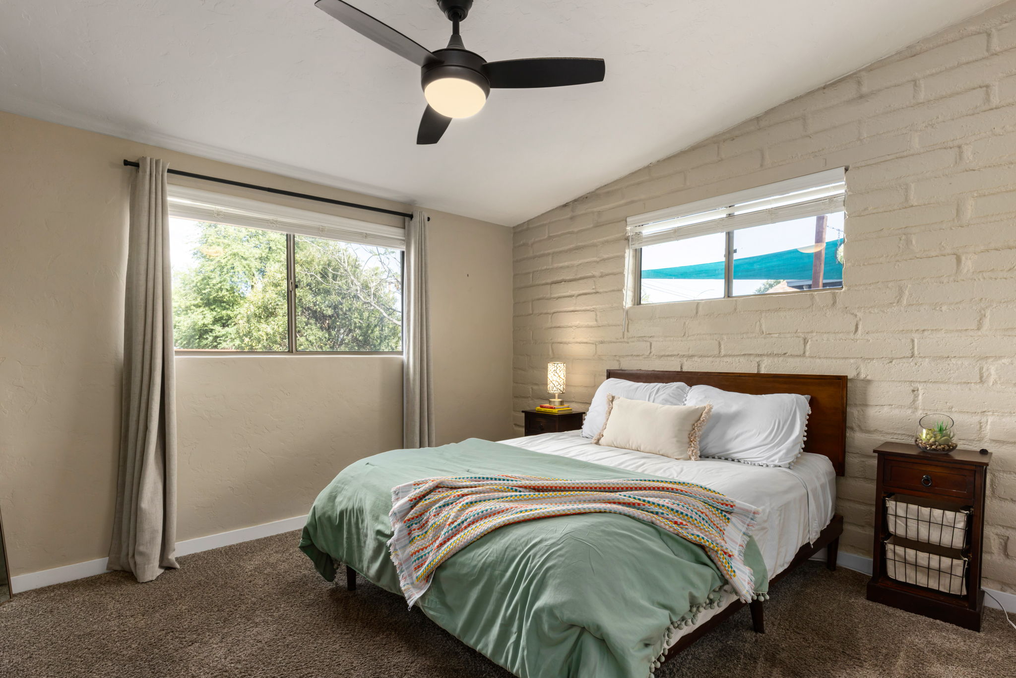 Third bedroom with ceiling fan, carpet and walk in closet.