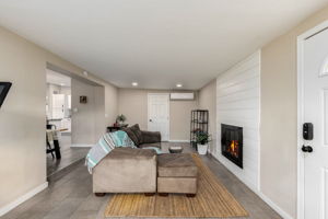 Landry room off the family room area with newer washer and dryer, plus water heater.
