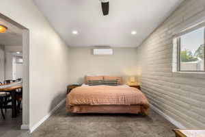 Primary bedroom with ceiling fan, newer carpet, and recessed lighting.
