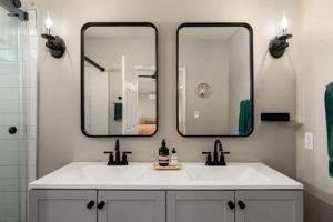 Updated primary bathrooms with double sink vanity.