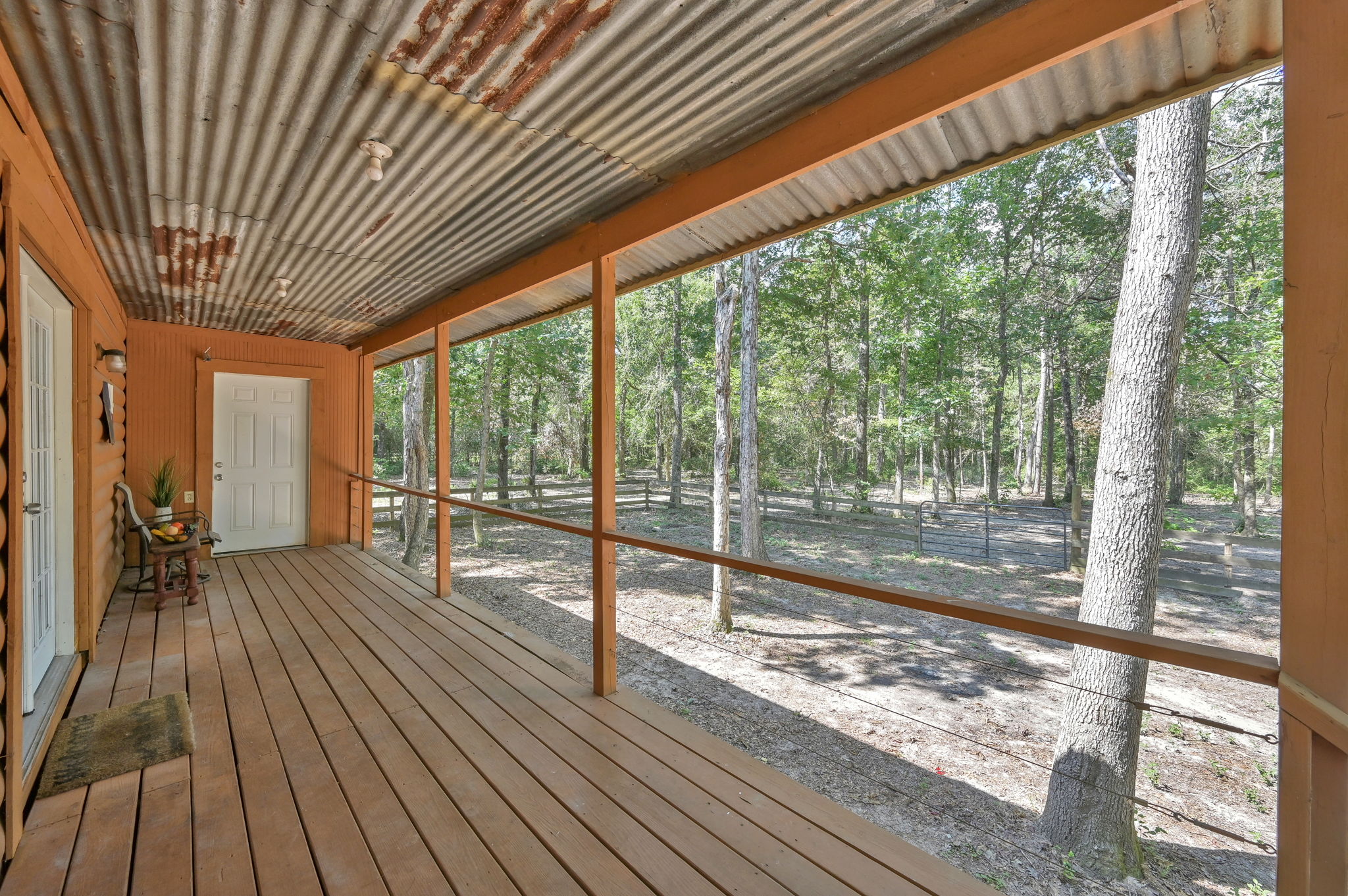BACK COVERED PORCH (approx. 26' x 7') w/ an additional good-sized STORAGE AREA on the far end.