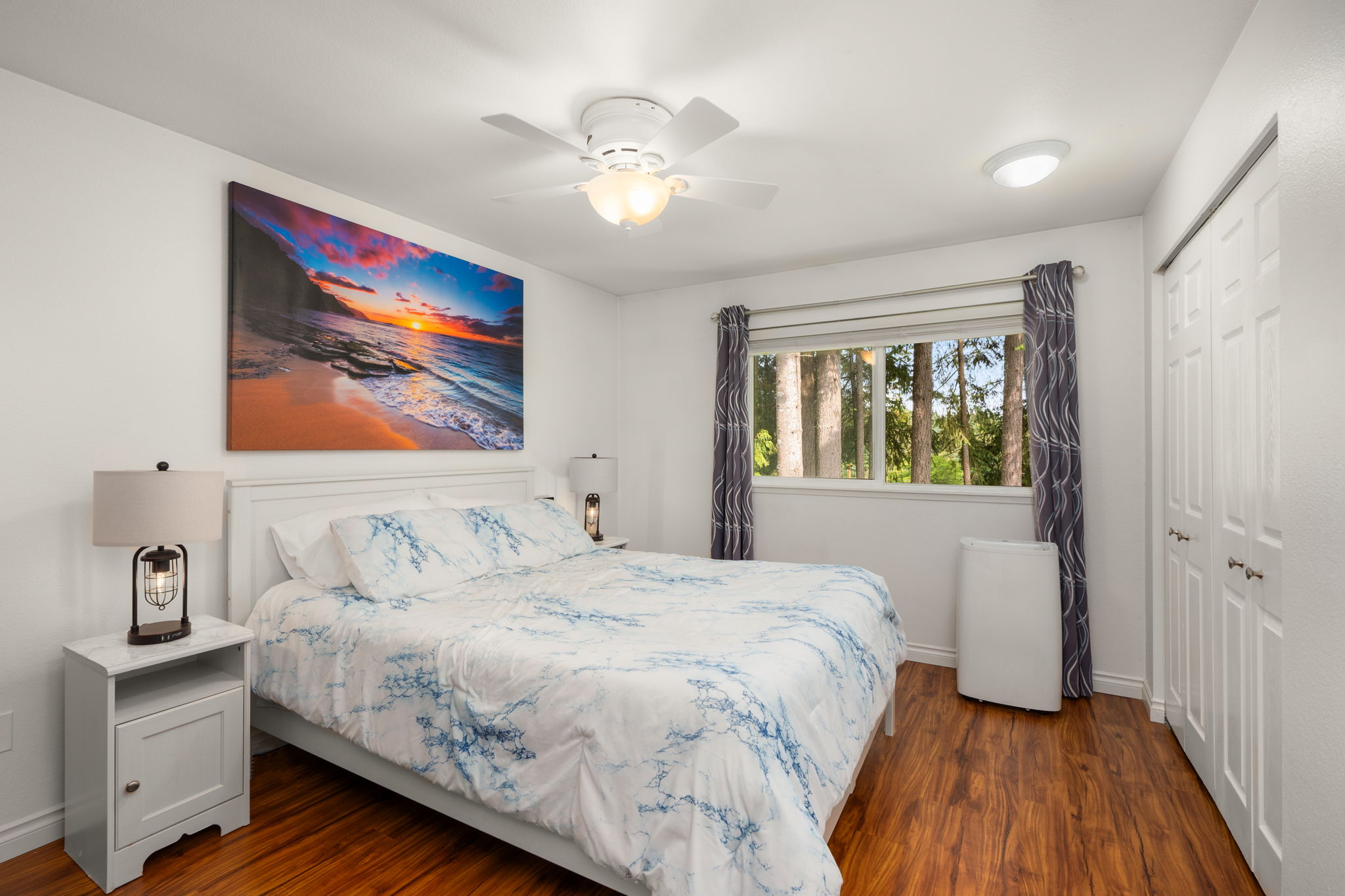 Upstairs primary suite overlooking greenbelt w/built-in high BTU A/C & ceiling fan.