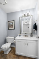 Guest 1/2 bath w/marble counter & SS faucet w/LED illuminated waterflow.