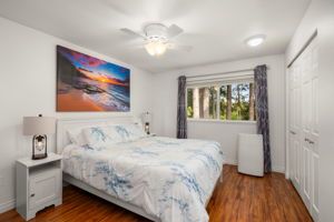Upstairs primary suite overlooking greenbelt w/built-in high BTU A/C & ceiling fan.