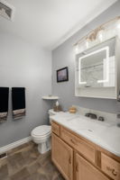 Upstairs hall guest bathroom w/new shower, fixtures, marble countertop, illuminated mirror & SS faucet w/LED illuminated waterflow.