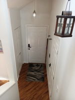 View of hall closet, entry door & door to garage.
