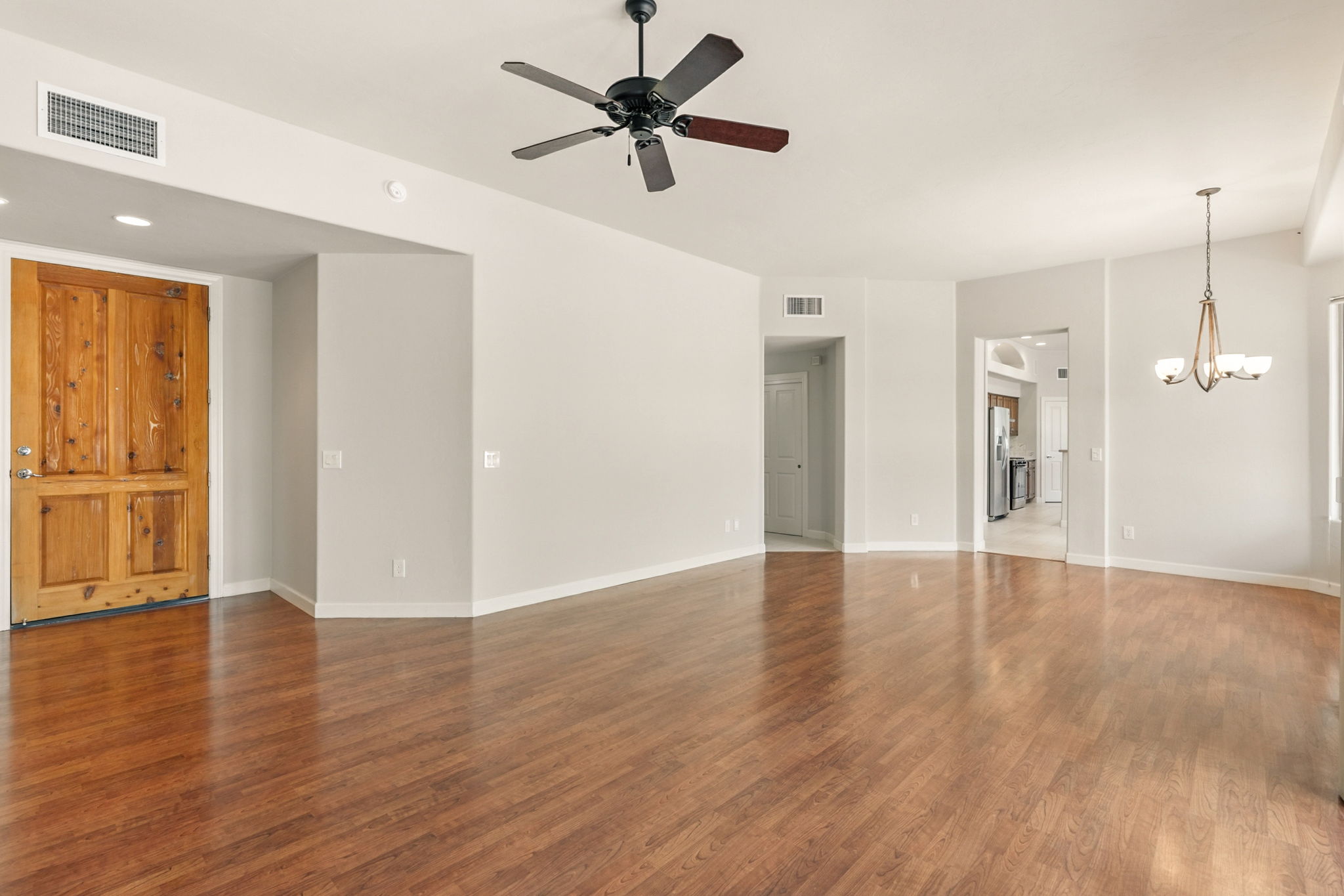 The living room and formal dining area feature durable wood-like laminate flooring