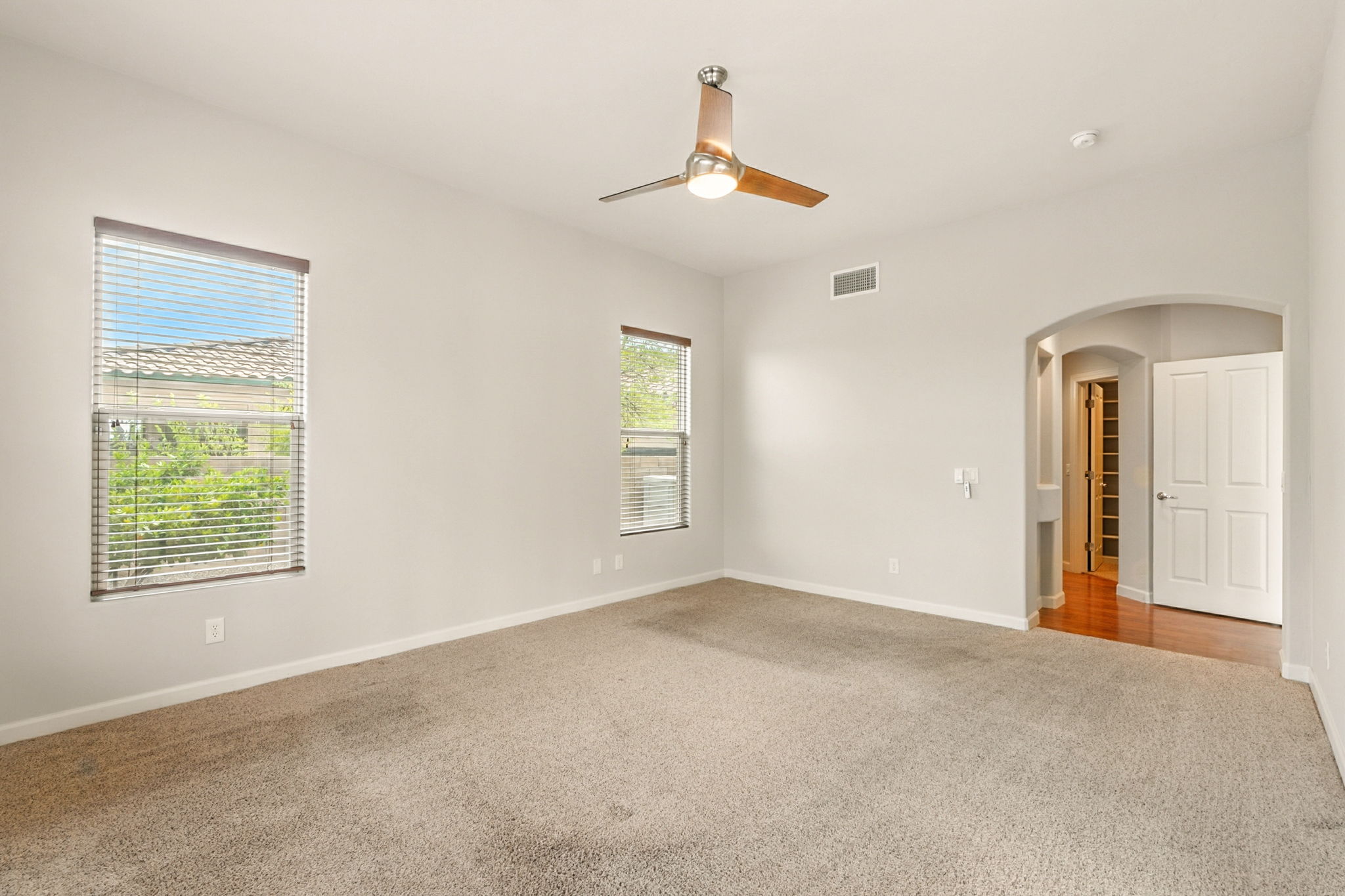 The owner's suite includes an elegant arched entry leading into the private en suite bath