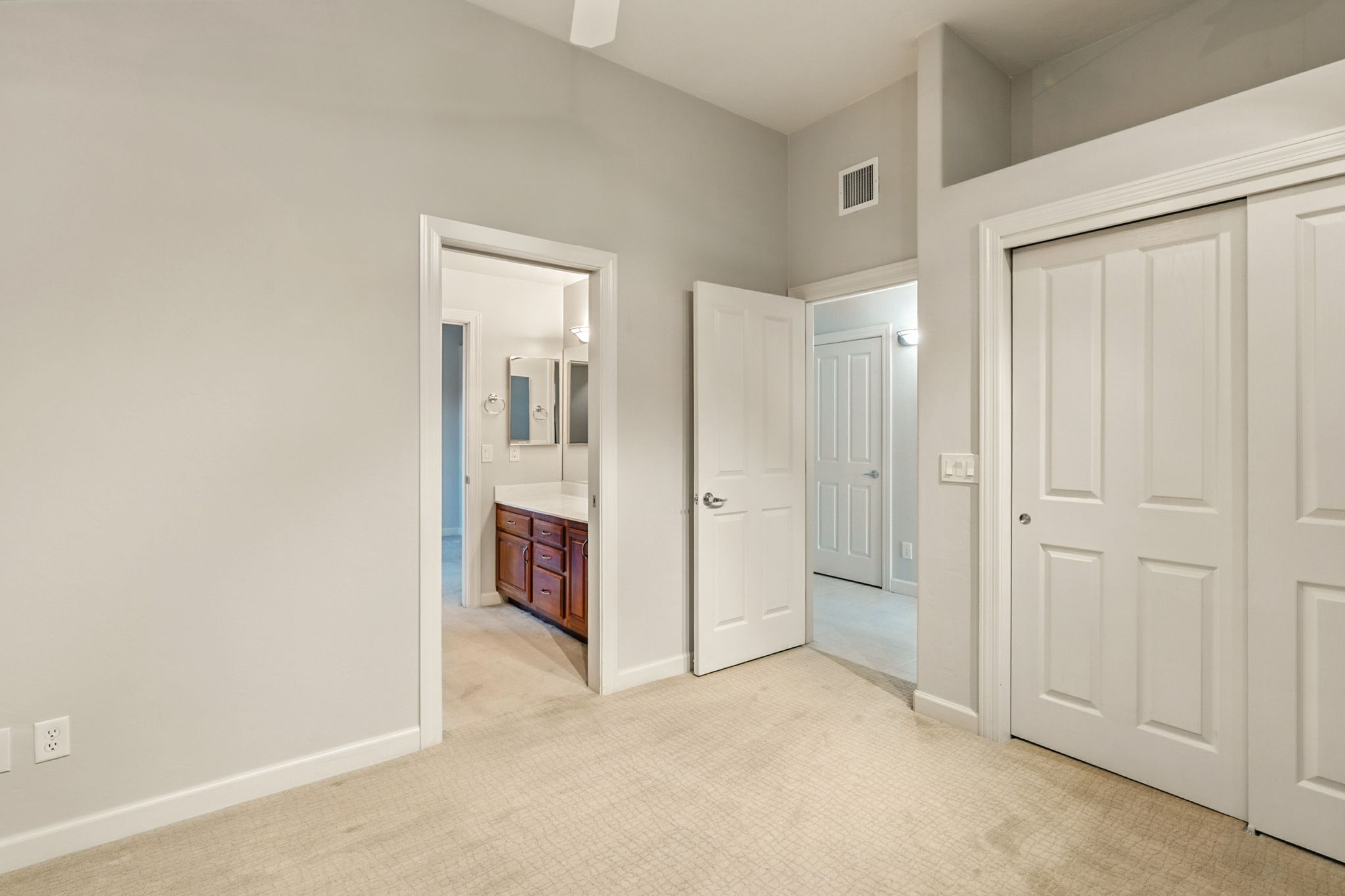 Bedroom two with spacious sliding-door closet and shared bath