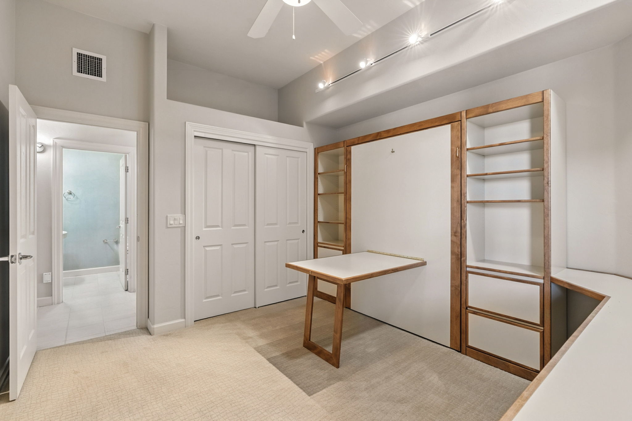 The murphy bed features a pull down table providing additional worksapce