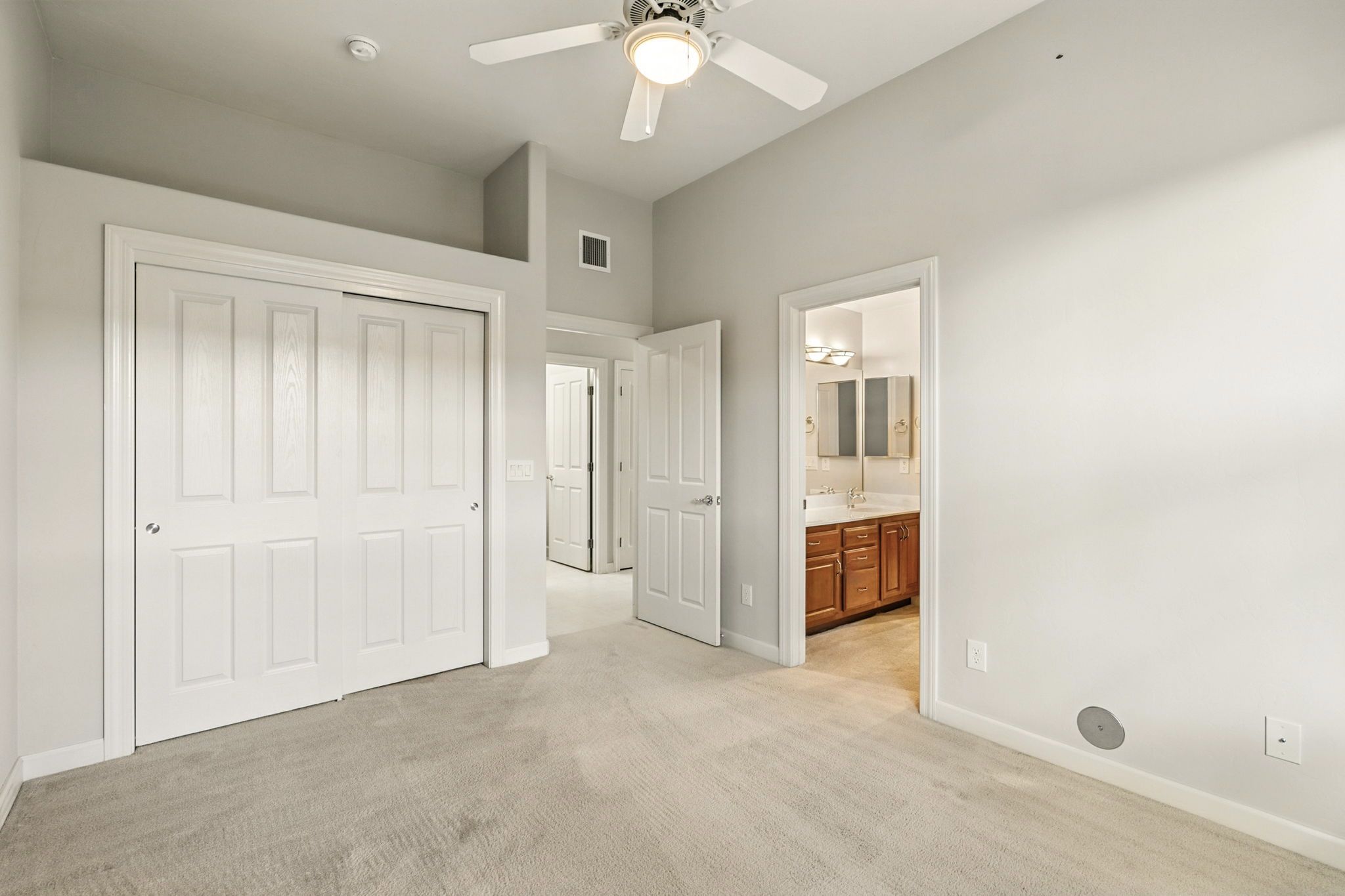Bedroom three with spacious sliding-door closet and shared bath