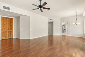 The living room and formal dining area feature durable wood-like laminate flooring