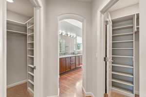 The en suite bath includes dual walk-in closets