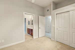 Bedroom two with spacious sliding-door closet and shared bath