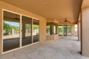 Expansive covered patio provides ample space for seating and outdoor dining