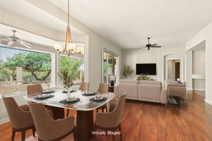 The formal dining area boasts a large bay window that frames the picturesque desert views