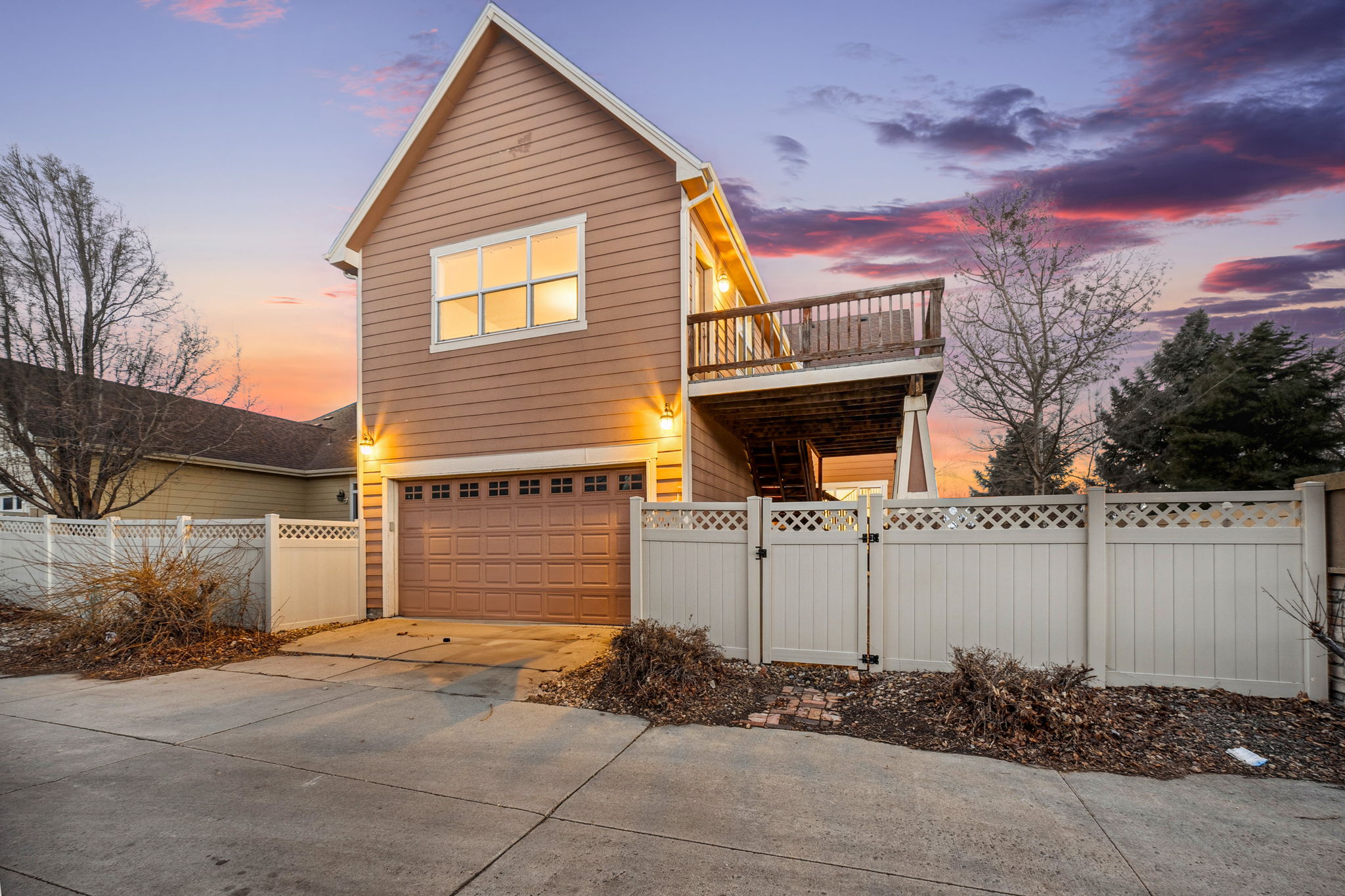 View of garage with bonus room and upstairs deck