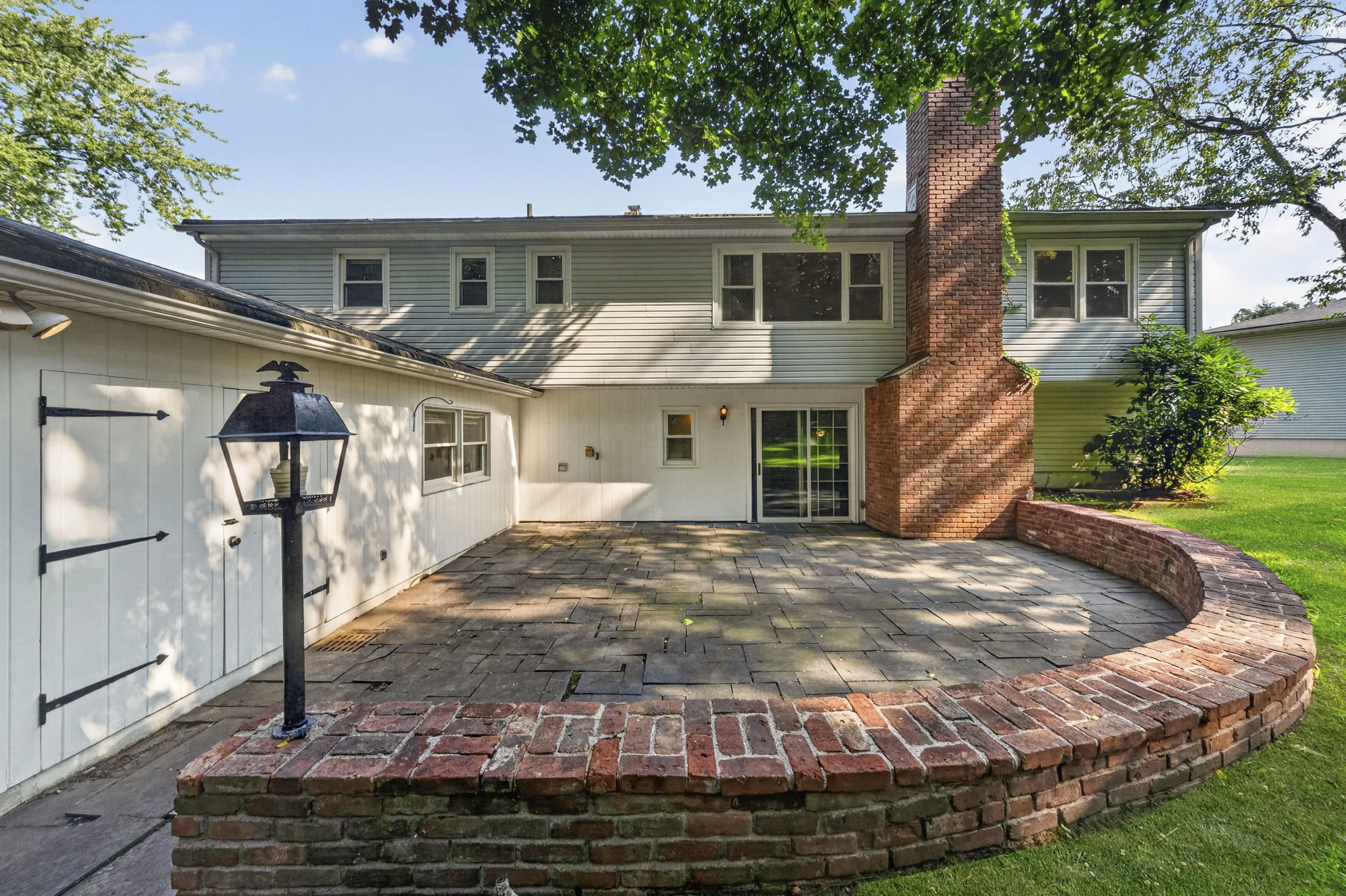 A large stone patio overlooks the expansive backyard, providing plenty of room to dine, relax, garden, or entertain throughout the seasons. With nearly 3/4 acre, this property offers the outdoor space so many buyers are searching for.