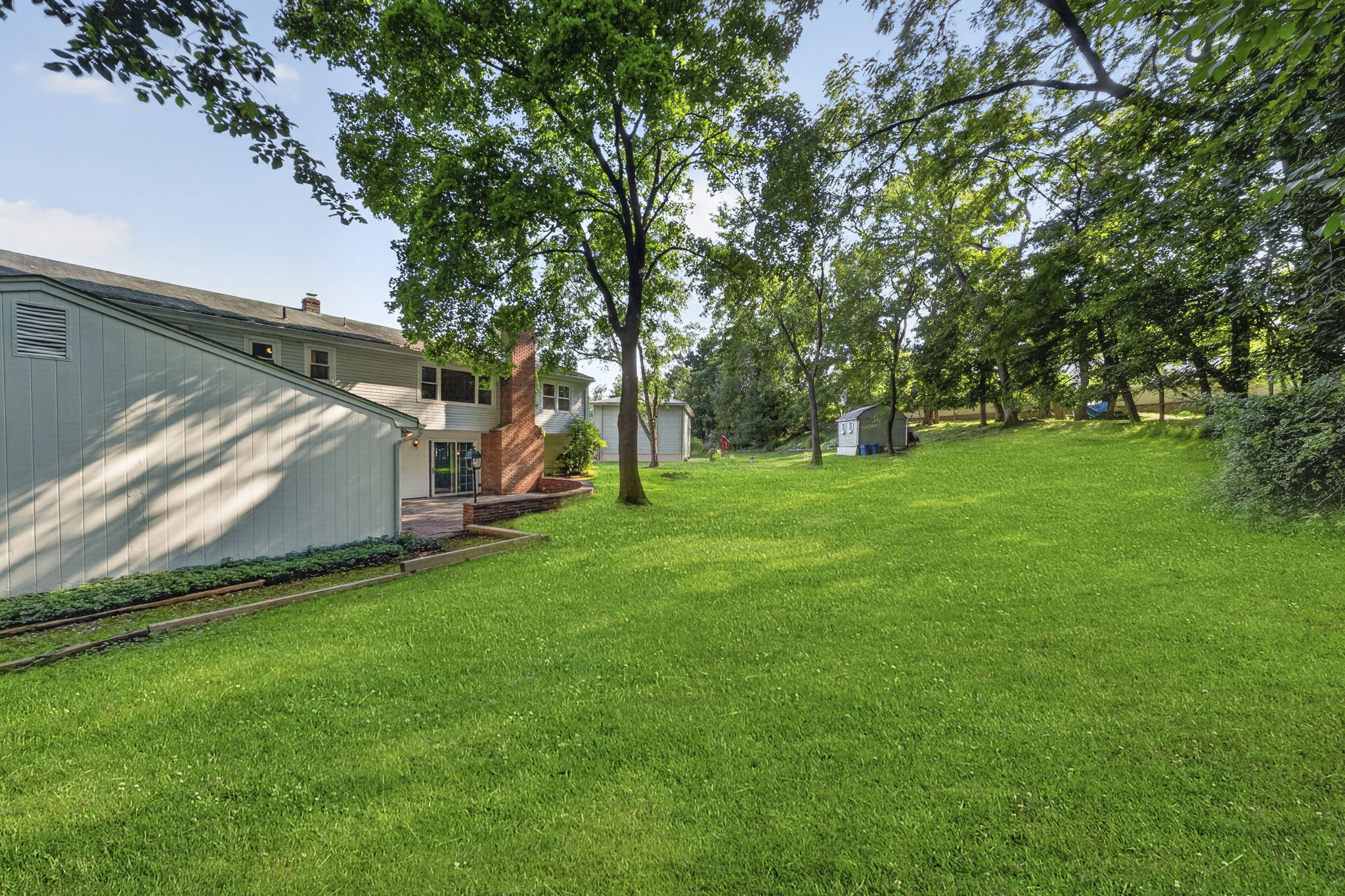 A large stone patio overlooks the expansive backyard, providing plenty of room to dine, relax, garden, or entertain throughout the seasons. With nearly 3/4 acre, this property offers the outdoor space so many buyers are searching for.